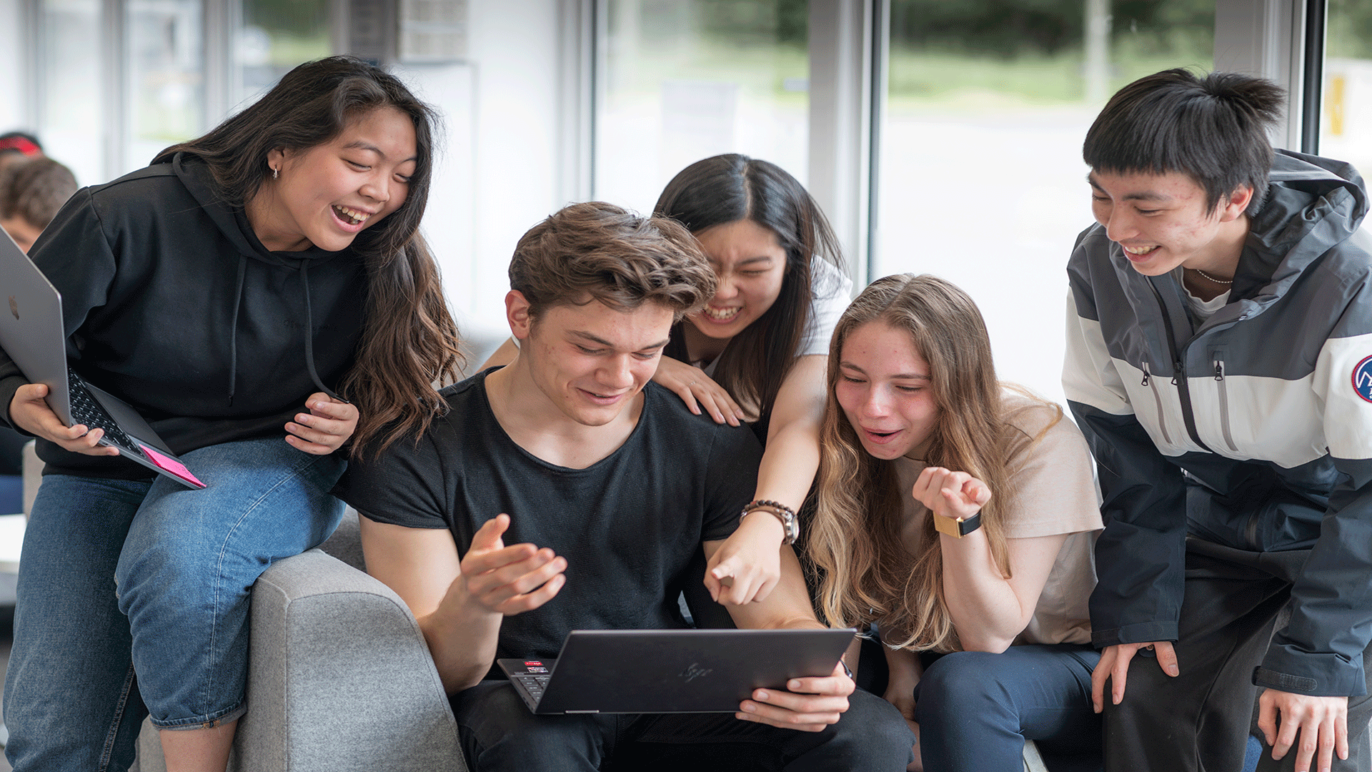 Students happily engaging together, during their studies