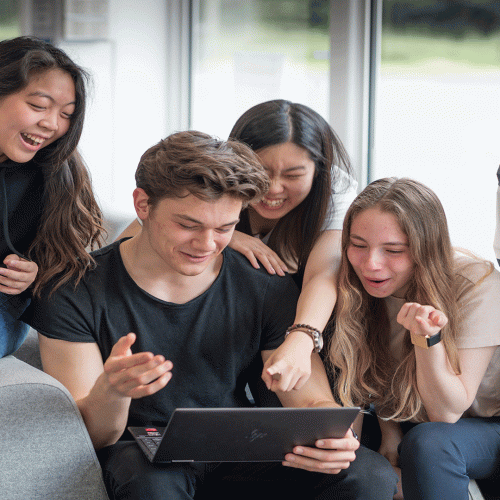 Students happily engaging together, during their studies